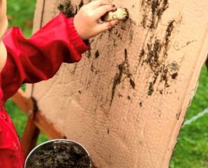 Child painting on cardboard