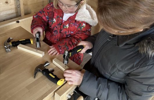 Adult and child working with wood